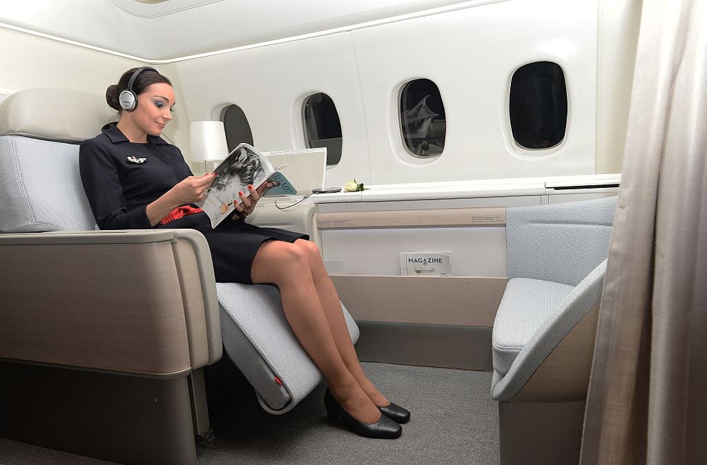 An Air France attendant shows off the airline's "haute couture" suite featuring a seat that reclines into a bed 