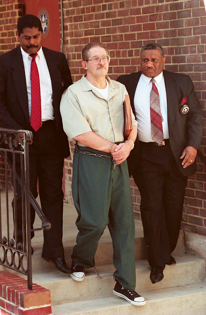 US marshalls escort Aldrich Ames (C) out of federal court