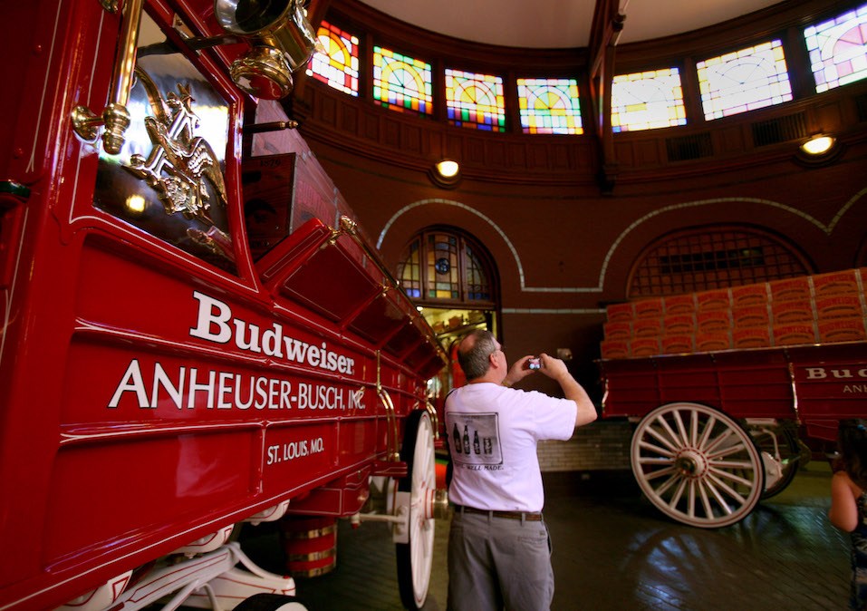 A visitor take a photo inside a stable for the Budweiser Clydesdales