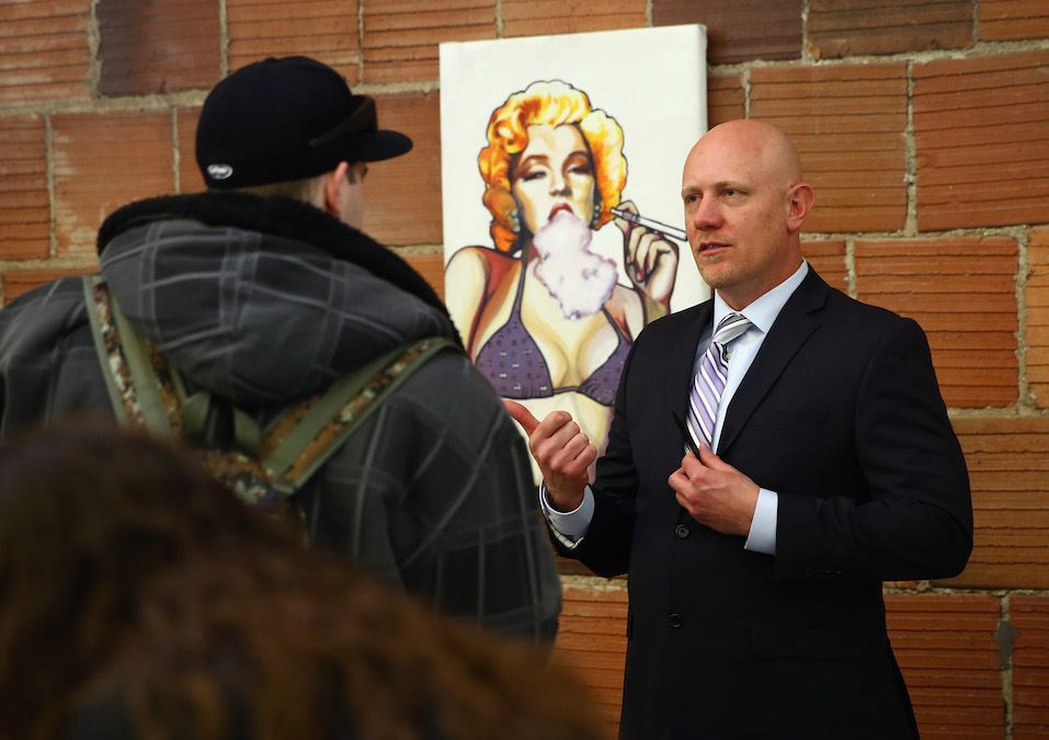 Tony Frischknecht of La Conte's Clone Bar and Dispensary talks with job seekers at CannaSearch
