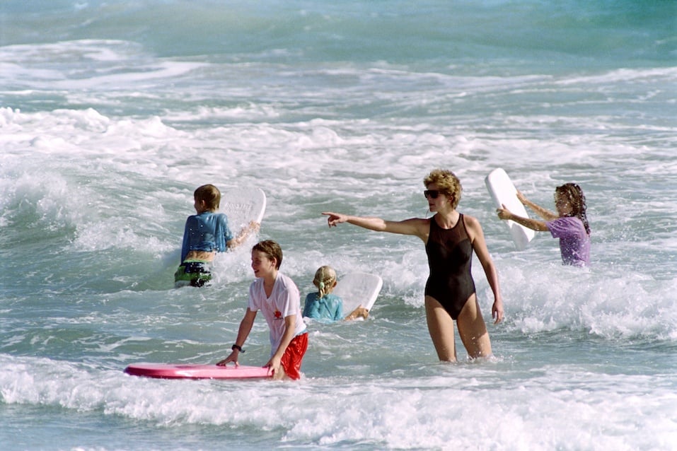 The Princess of Wales heads out into the surf as her sons William and Harry enjoy the waters of Indian Castle Beach