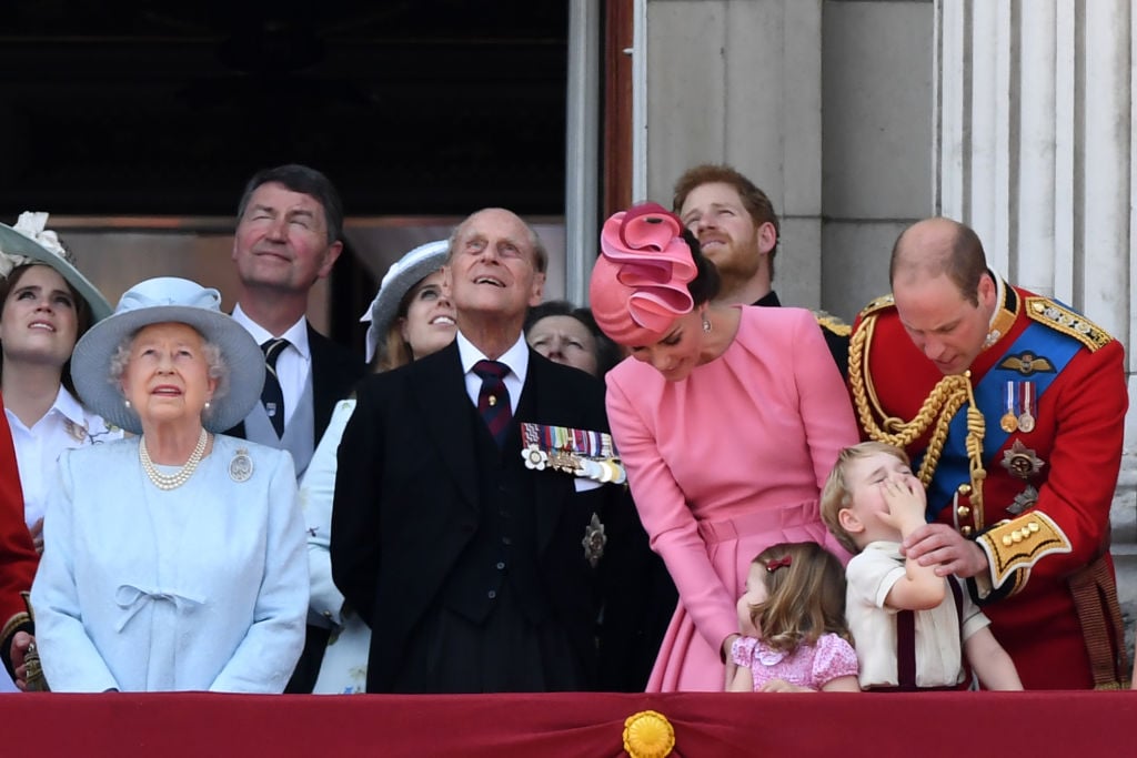 Britain's Prince Harry and Britain's Prince William, Duke of Cambridge, stand on the balcony of Buckingham Palace to watch a fly-past of aircraft by the Royal Air Force