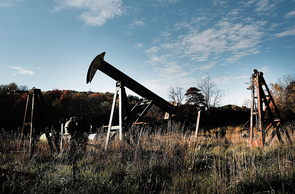 Pumps used in the oil business sit in a yard