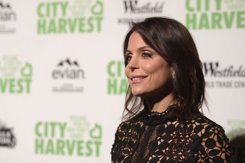 Bethenny Frankel wearing a black lace dress on a red carpet. Bethenny Frankel wearing a black lace dress on a red carpet.