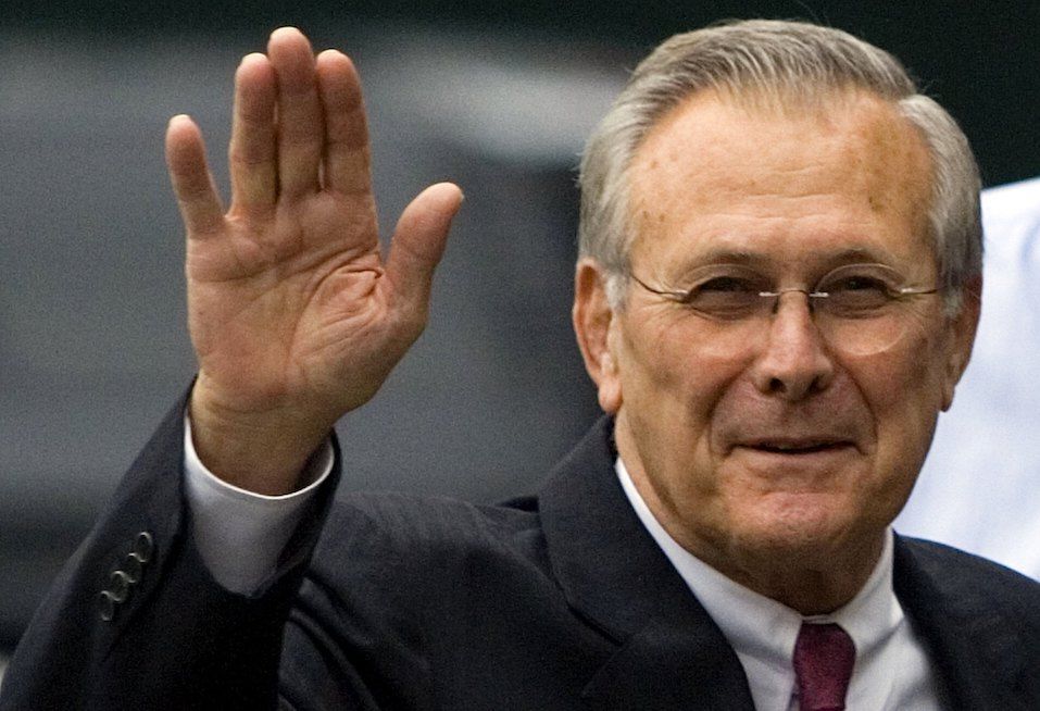 U.S. Secretary of Defense Donald Rumsfeld waves from outside the White House