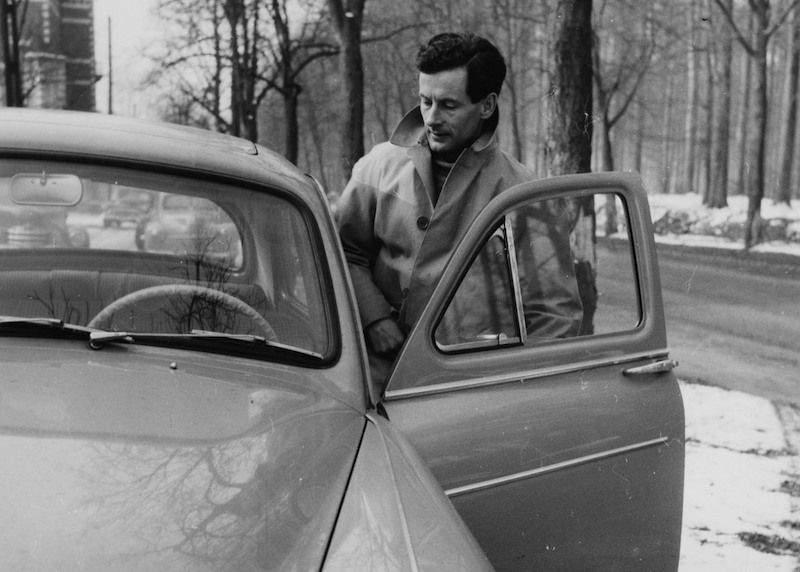 Captain Peter Townsend entering a car. Captain Peter Townsend entering a car.