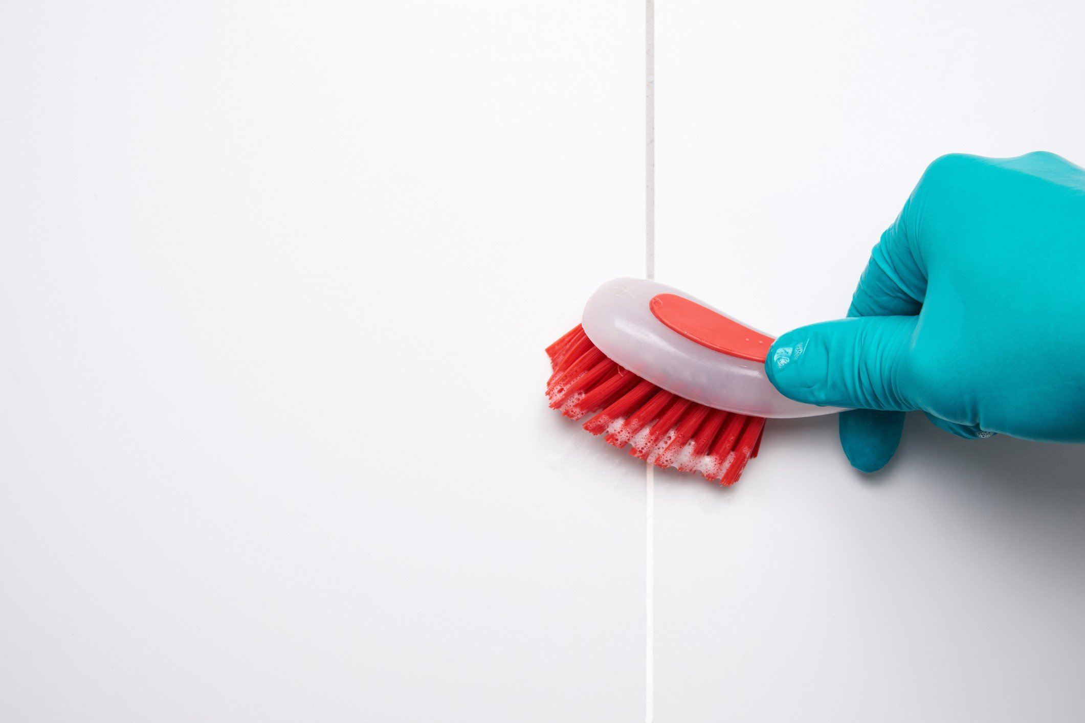Cleaning shower or bathroom grout with a scrub brush