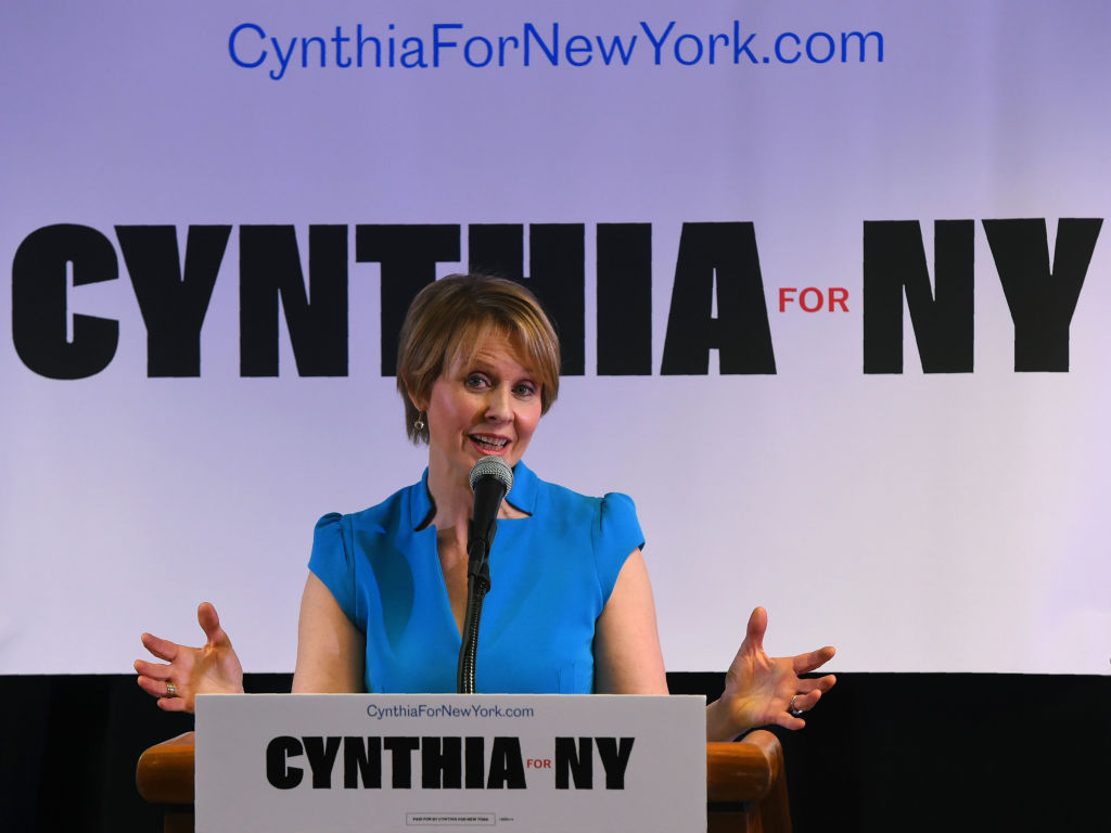 Cynthia Nixon speaking at a podium