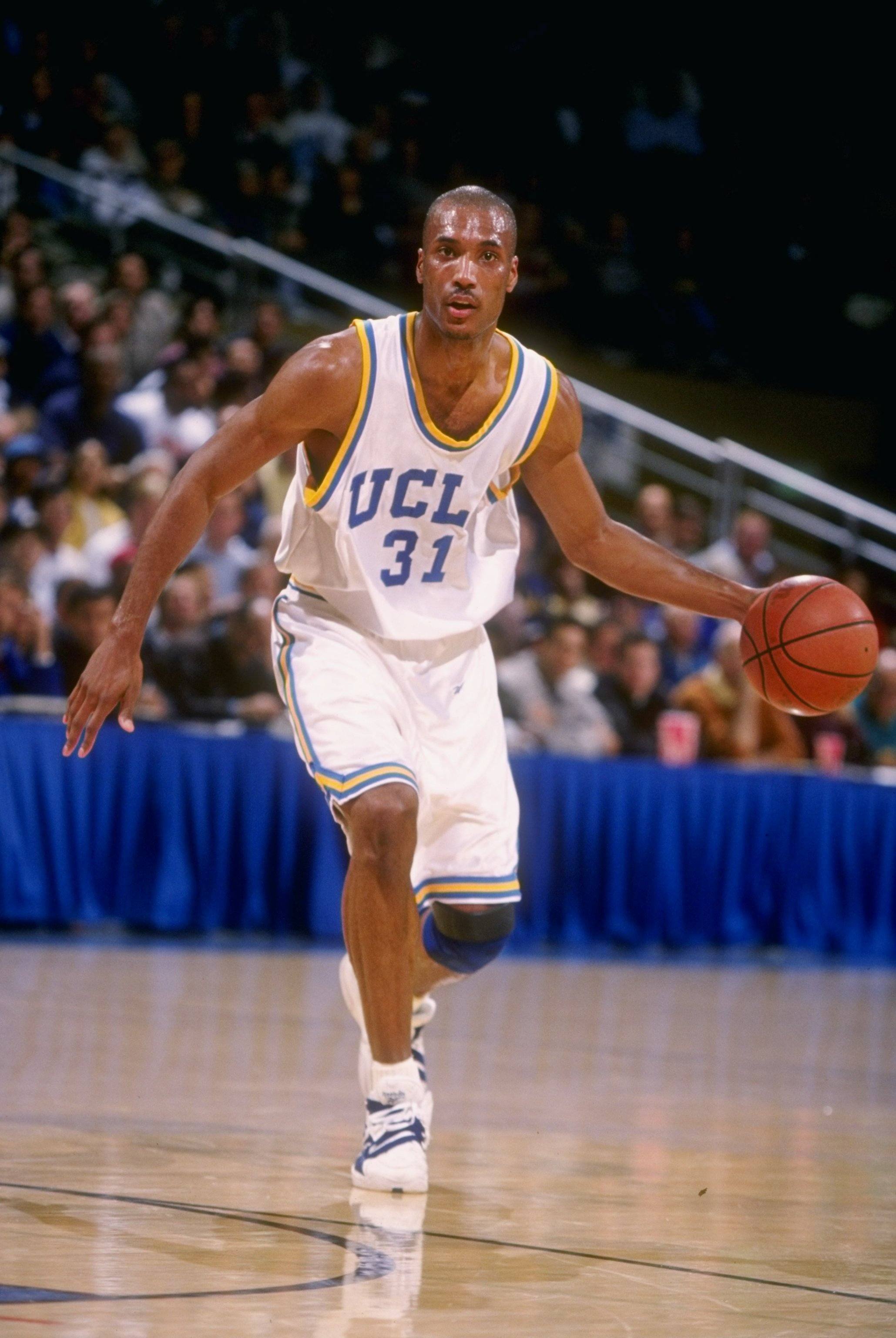Ed O'Bannon dribbles a ball