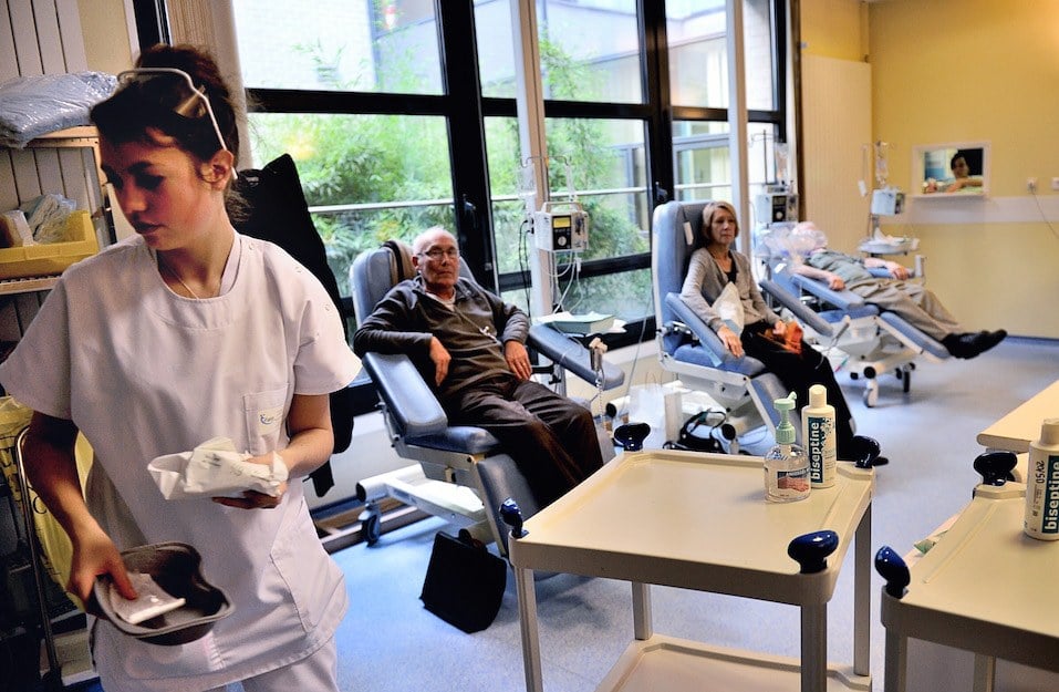 A nurse is working in a room where patients undergo chemotherapy treatment