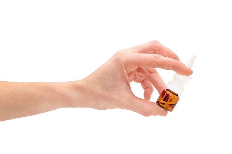 Female hand holds nasal spray.