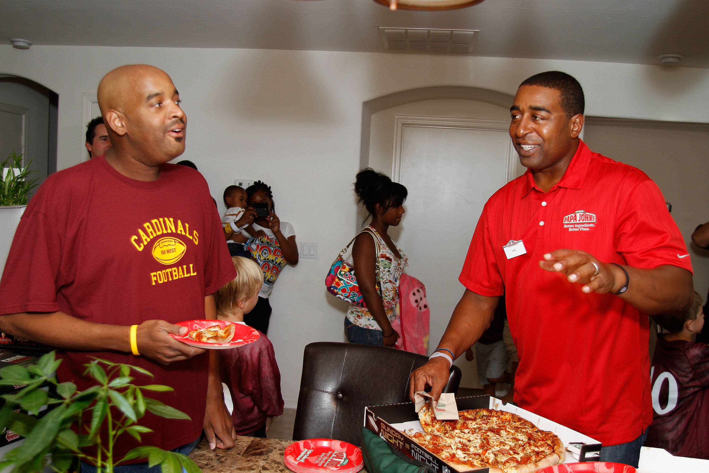Papa Johns contest winner Anthony Green and Former NFL Star Cris Carter watch the NFL kickoff game on September 9, 2010 in Phoenix, Arizona. Papa Johns contest winner Anthony Green and Former NFL Star Cris Carter watch the NFL kickoff game on September 9, 2010 in Phoenix, Arizona.