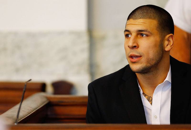 NORTH ATTLEBORO, MA - AUGUST 22: Aaron Hernandez sits in the courtroom of the Attleboro District Court during his hearing on August 22, 2013 in North Attleboro, Massachusetts. Former New England Patriot Aaron Hernandez has been indicted on a first-degree murder charge for the death of Odin Lloyd. (Photo by Jared Wickerham/Getty Images) NORTH ATTLEBORO, MA - AUGUST 22: Aaron Hernandez sits in the courtroom of the Attleboro District Court during his hearing on August 22, 2013 in North Attleboro, Massachusetts. Former New England Patriot Aaron Hernandez has been indicted on a first-degree murder charge for the death of Odin Lloyd. (Photo by Jared Wickerham/Getty Images)