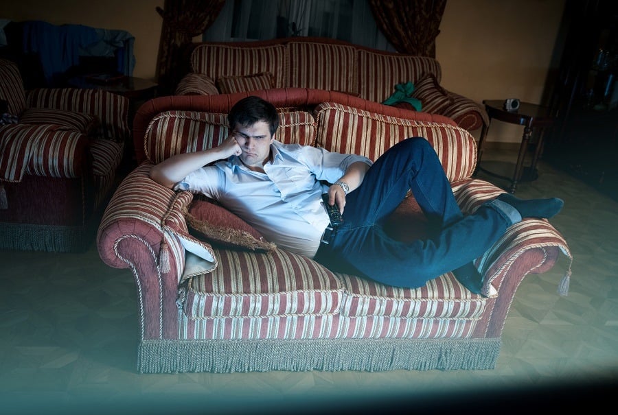 man watching TV at night