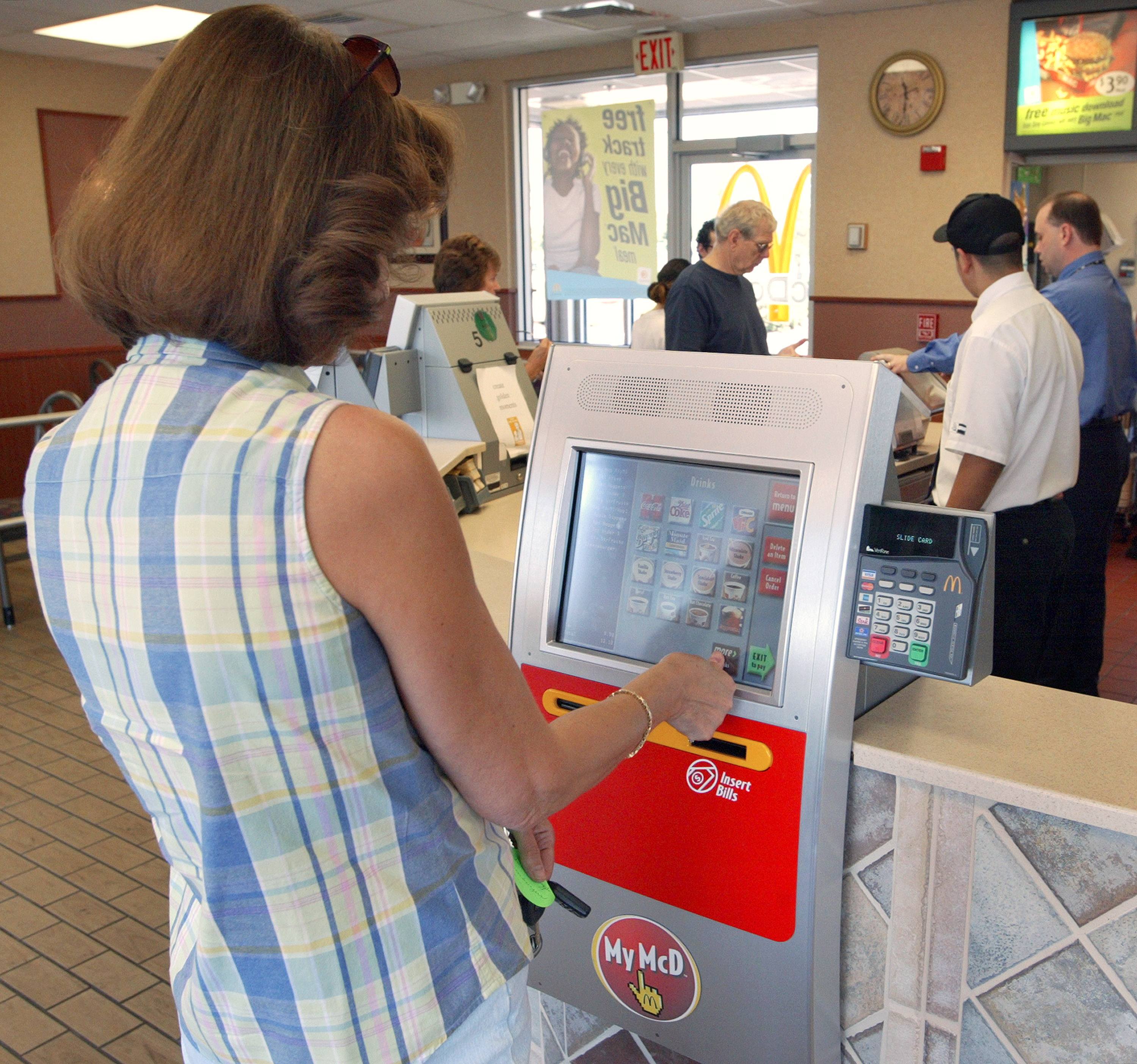 woman using a McDonald's kiosk