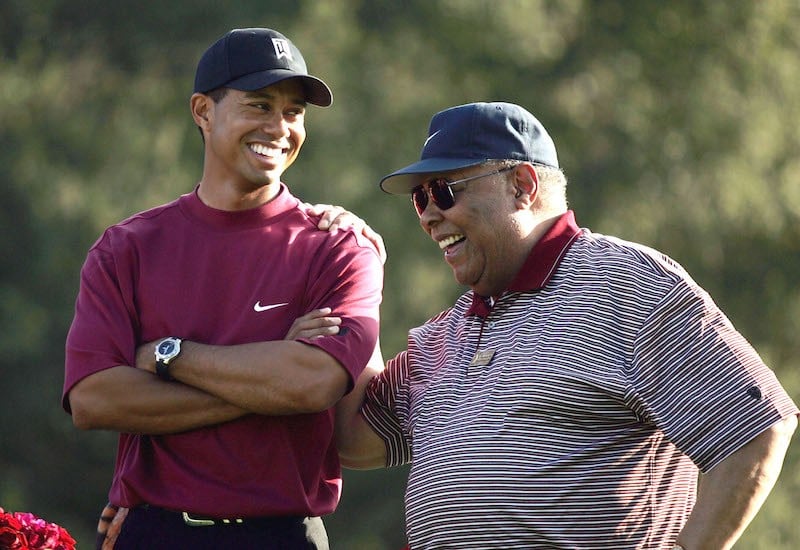 THOUSAND OAKS, CA - DECEMBER 12: Tiger Woods (L) smiles as he stands with his father, Earl Woods, during the trophy presentation of the Target World Challenge on December 12, 2004 at Sherwood Country Club in Thousand Oaks, California. Woods won the event at 16 under par. (Photo by Doug Benc/Getty Images)