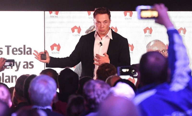 Elon Musk speaks to a crowd in 2017