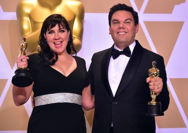 Kristen Anderson-Lopez and Robert Lopez pose in the press room with the Oscar for Original Song during the 90th Annual Academy Awards on March 4, 2018, in Hollywood, California. / AFP PHOTO / FREDERIC J. BROWN (Photo credit should read FREDERIC J. BROWN/AFP/Getty Images) Kristen Anderson-Lopez and Robert Lopez pose in the press room with the Oscar for Original Song during the 90th Annual Academy Awards on March 4, 2018, in Hollywood, California. / AFP PHOTO / FREDERIC J. BROWN (Photo credit should read FREDERIC J. BROWN/AFP/Getty Images)