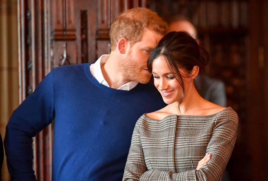 Prince Harry whispers in Meghan Markle's ear