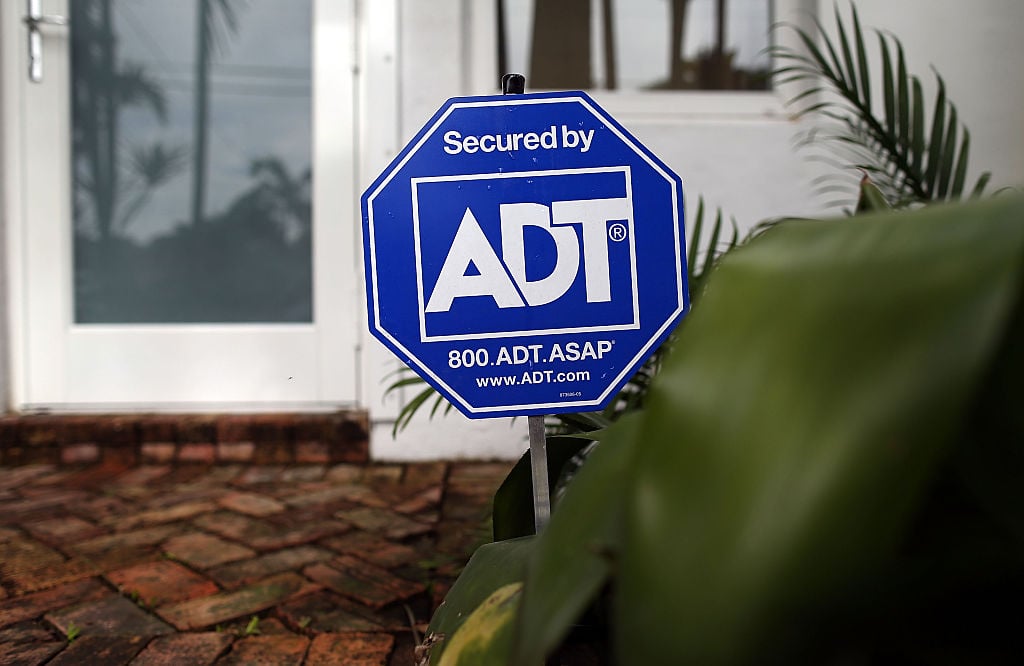 ADT home security sign in front of window