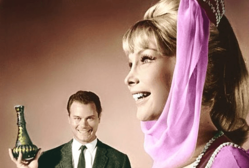 A man holds lamp while smiling at the genie. A man holds lamp while smiling at the genie.