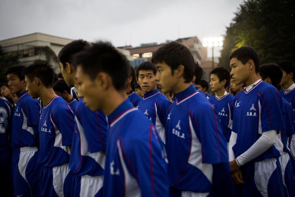 students attend a football training session at Tokyo Korean high school