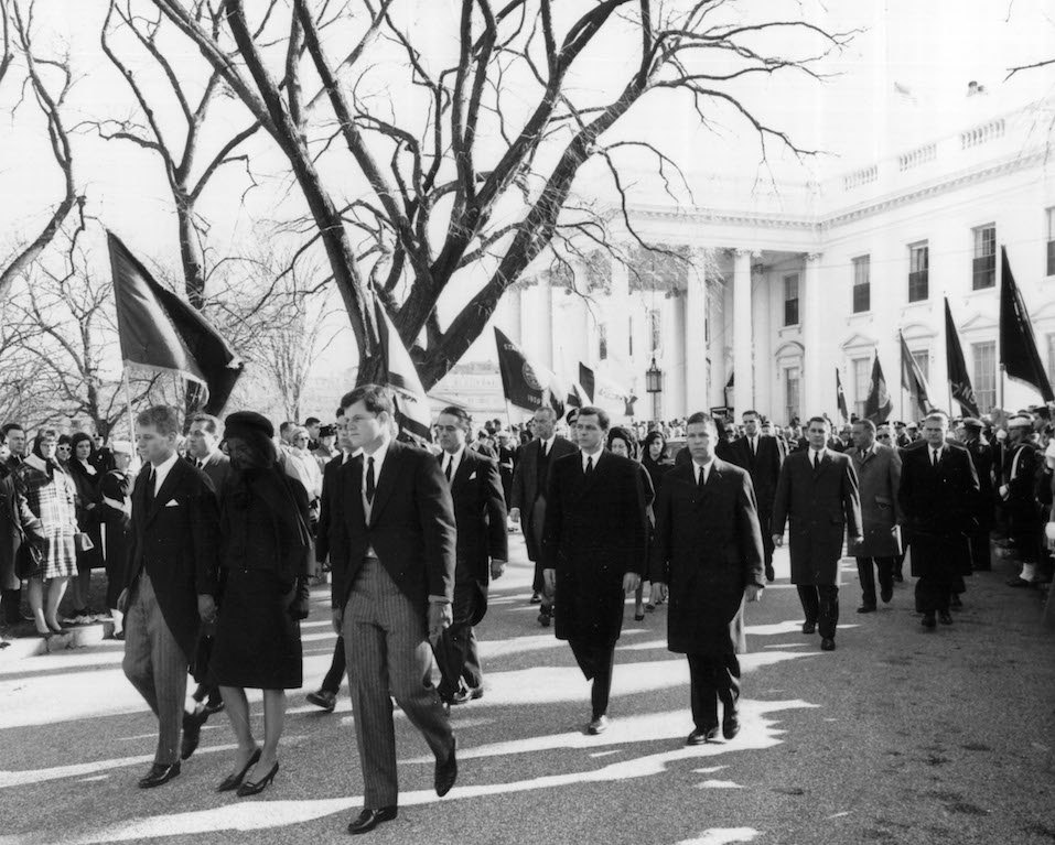 Robert and Edward Kennedy escort Jackie Kennedy from the White House to attend the funeral of President John F. Kennedy