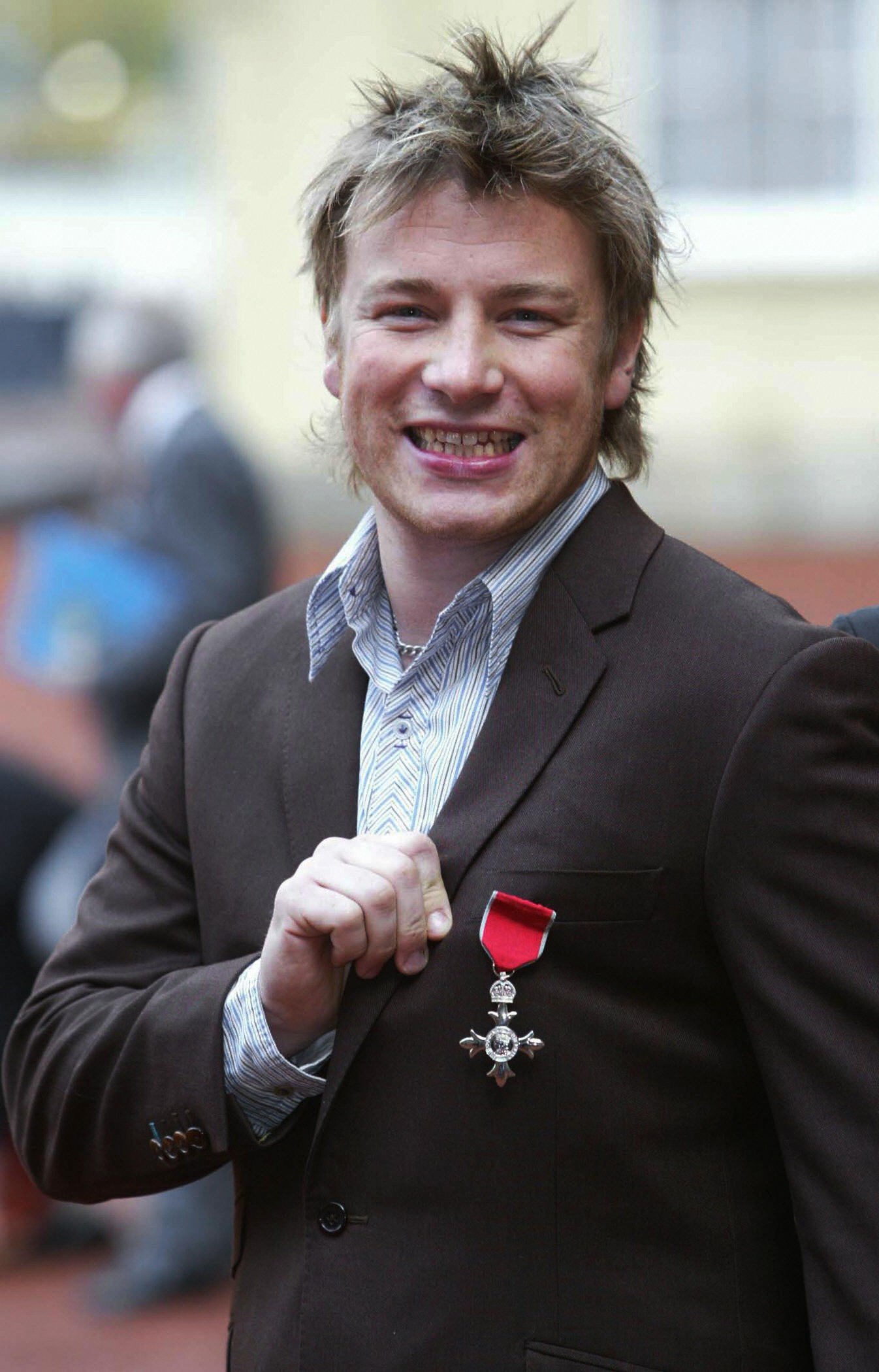 Celeberty Chef Jamie Oliver poses with his MBE award