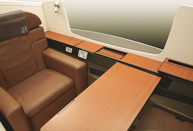 Japan airlines first class brown leather recliner seat.
