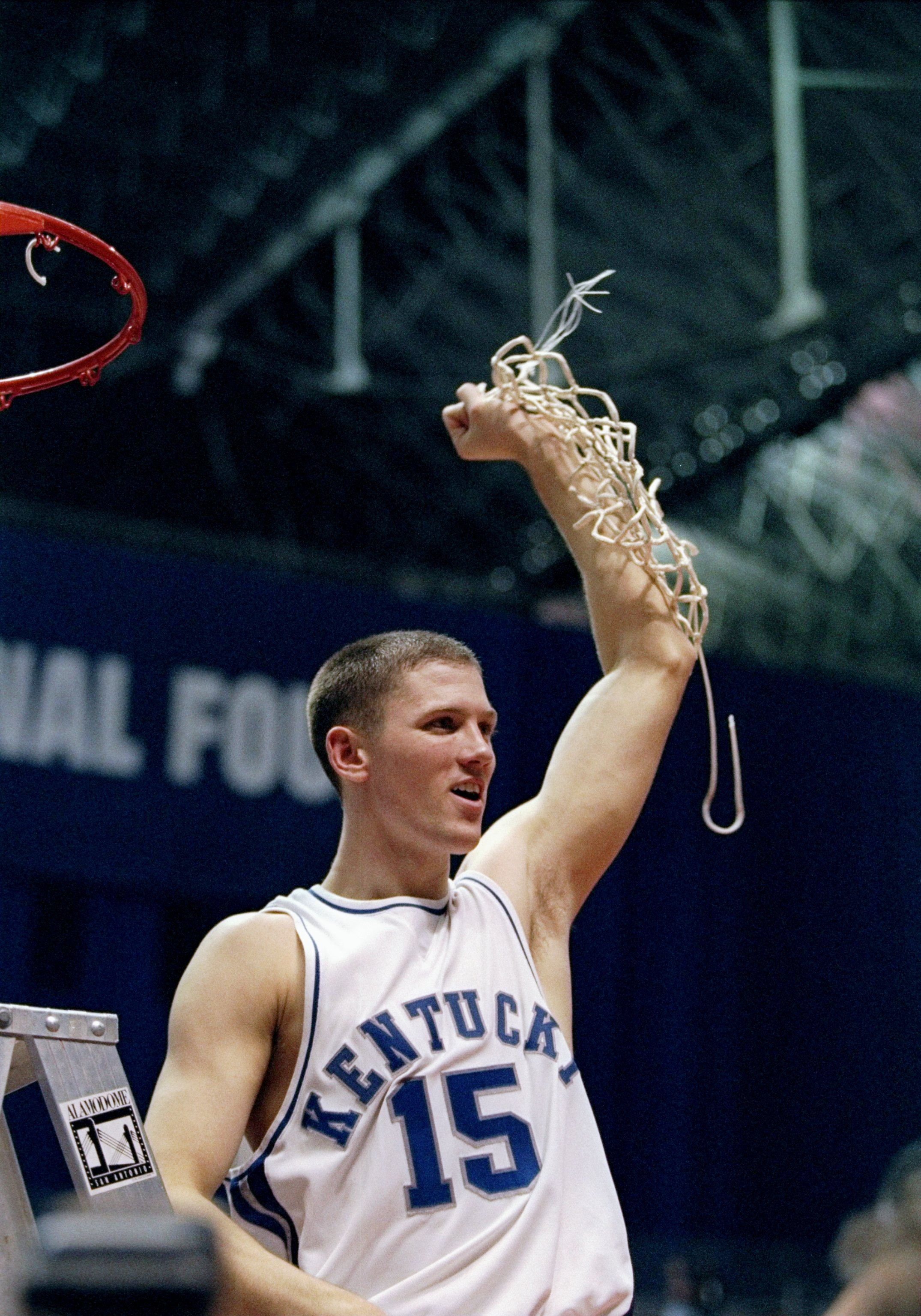 Jeff Sheppard #15 of the Kentucky Wildcats celebrates a victory over the Utah Utes by cutting down the net