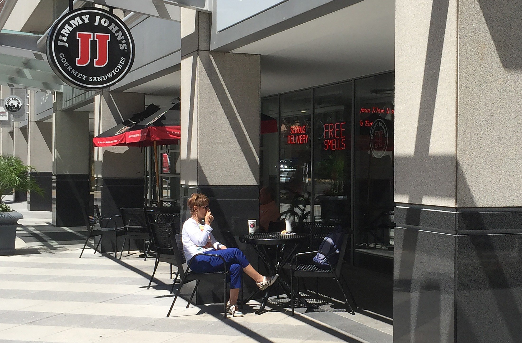 People sit outside one of the shops of Jimmy John's People sit outside one of the shops of Jimmy John's