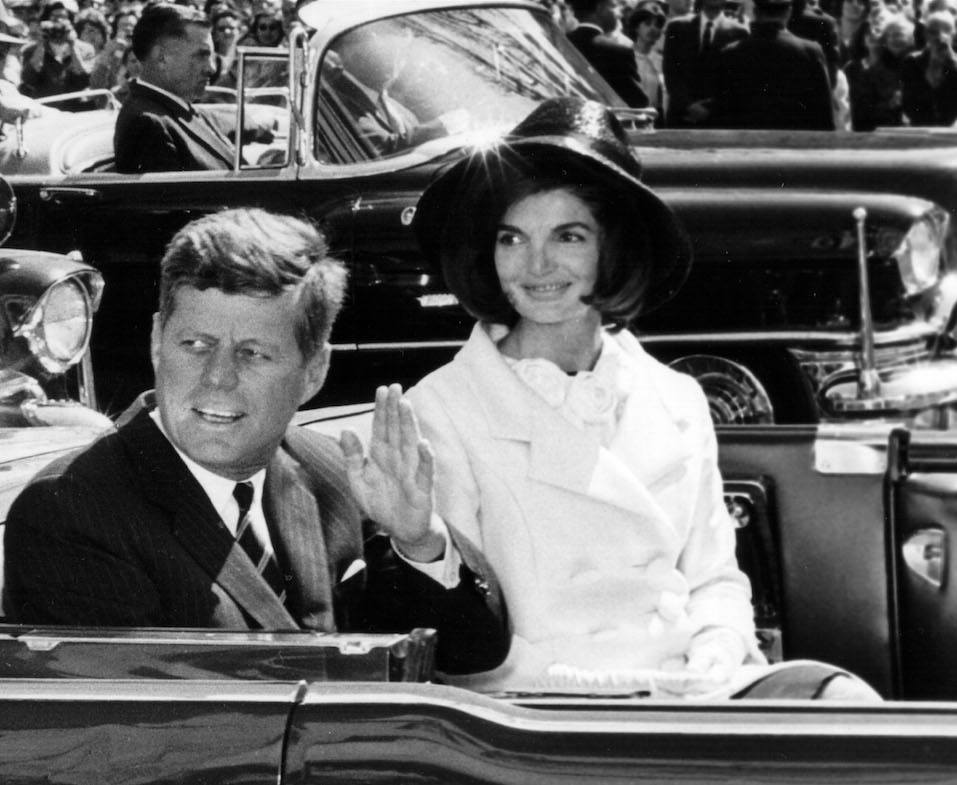 President John F. Kennedy and First Lady Jacqueline Kennedy ride in a parade.