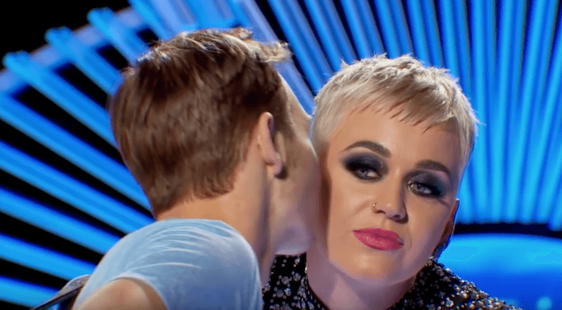 Katy Perry being kissed by Benjamin Glaze. 