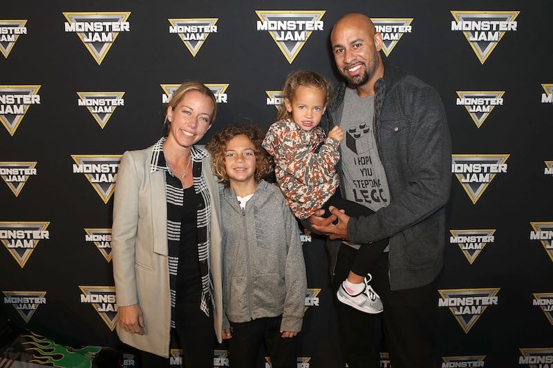 Kendra smiles on a red carpet with her family. Kendra smiles on a red carpet with her family.