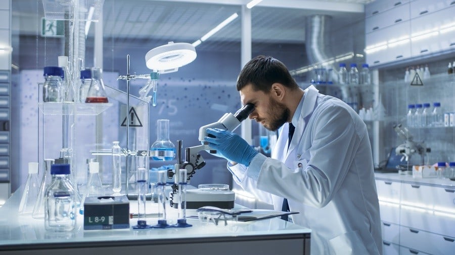 Research Scientist Looks into Microscope