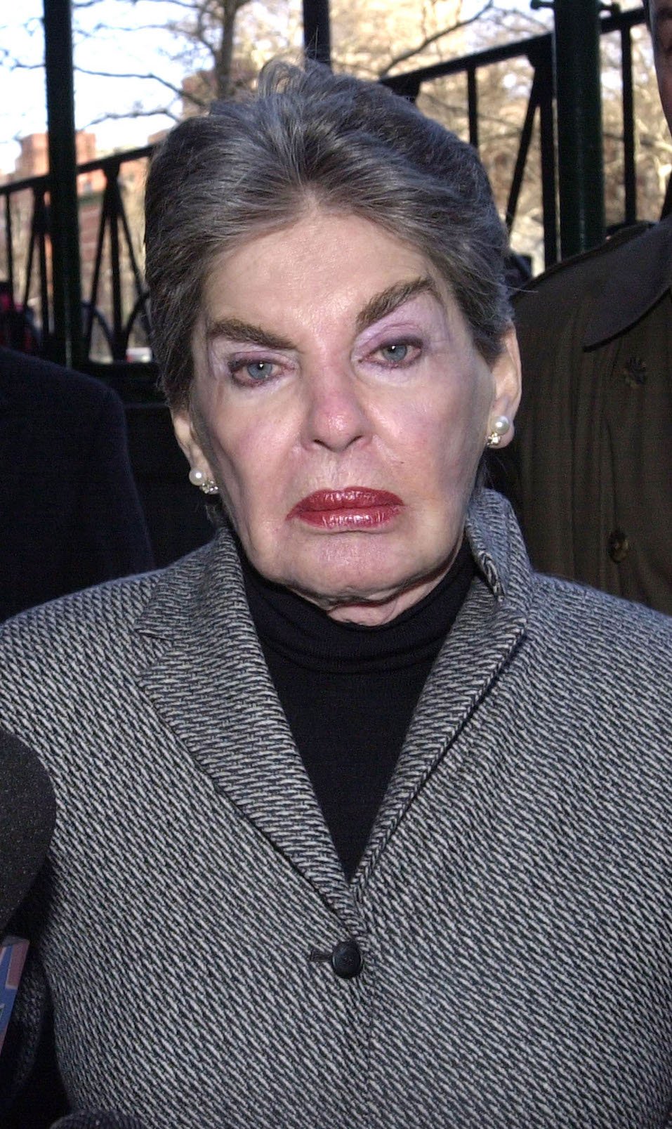 Real estate mogul Leona Helmsley is aided by her body guards as she arrives to court