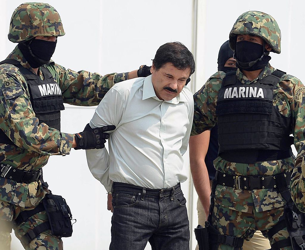 Mexican drug trafficker Joaquin Guzman Loera aka "el Chapo Guzman" is escorted by marines as he is presented to the press