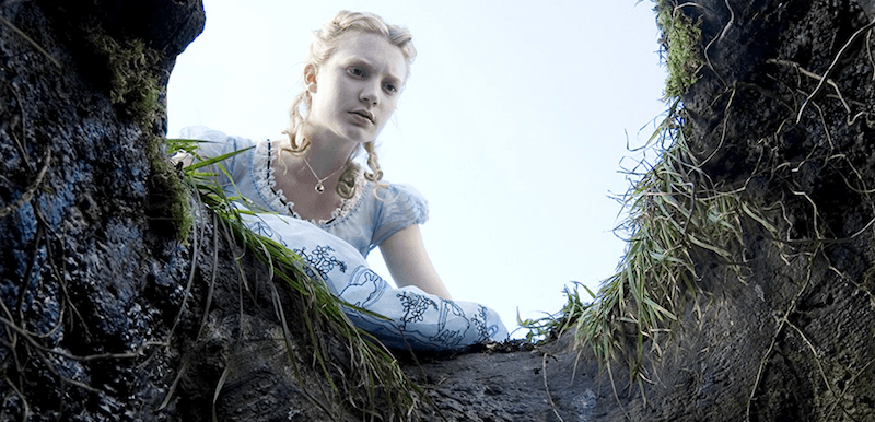Alice looks into a big hole in the ground. Alice looks into a big hole in the ground.