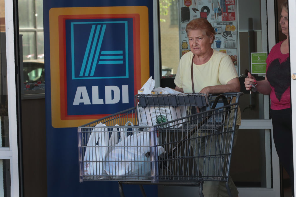 Customers shop at an Aldi grocery store Customers shop at an Aldi grocery store