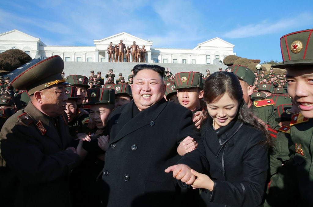 North Korean leader Kim Jong-Un (C) and his wife Ri Sol-Ju