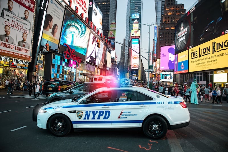 NYPD police squad car goes to emergency call with alarm