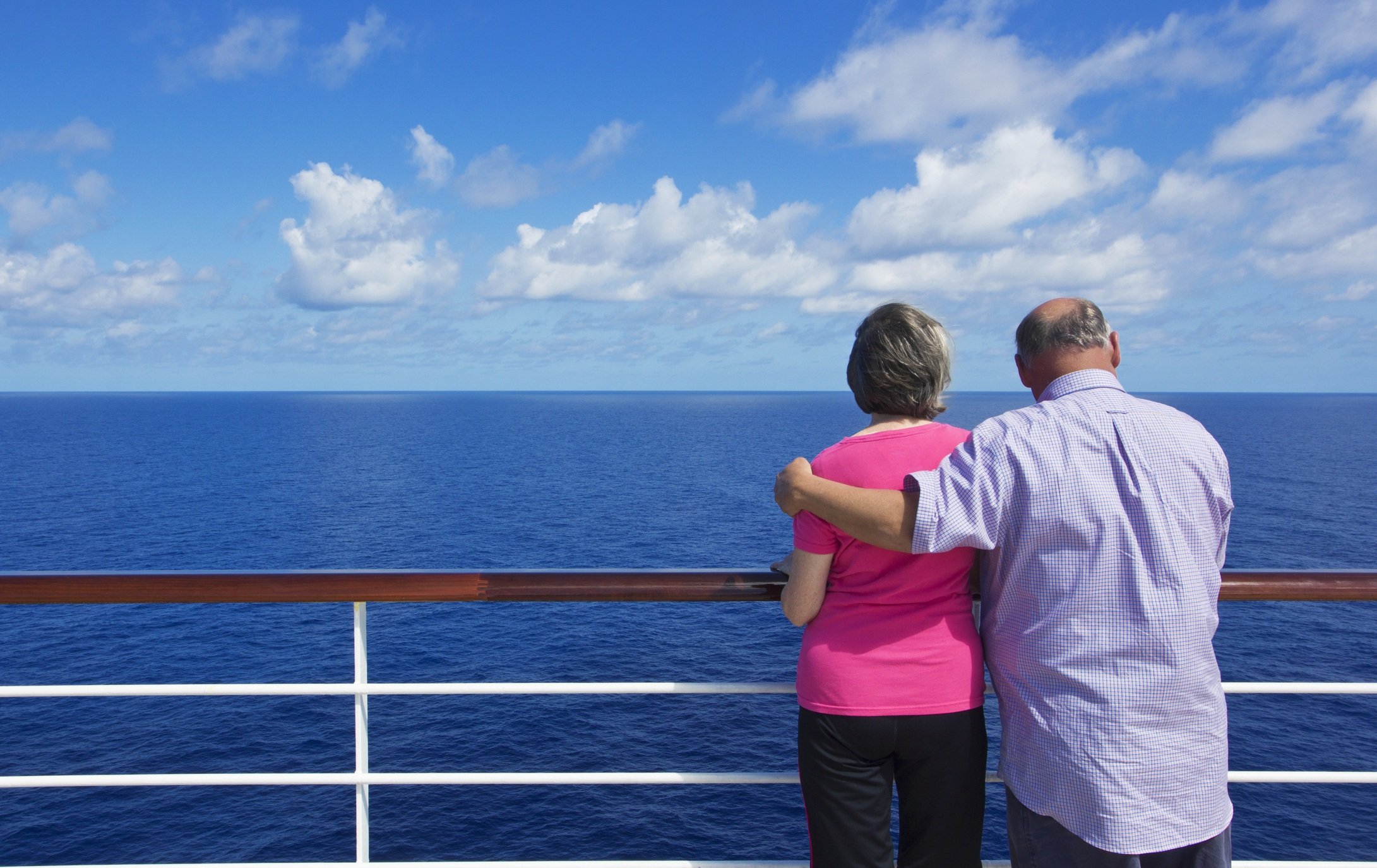 A senior couple looking out at the ocean