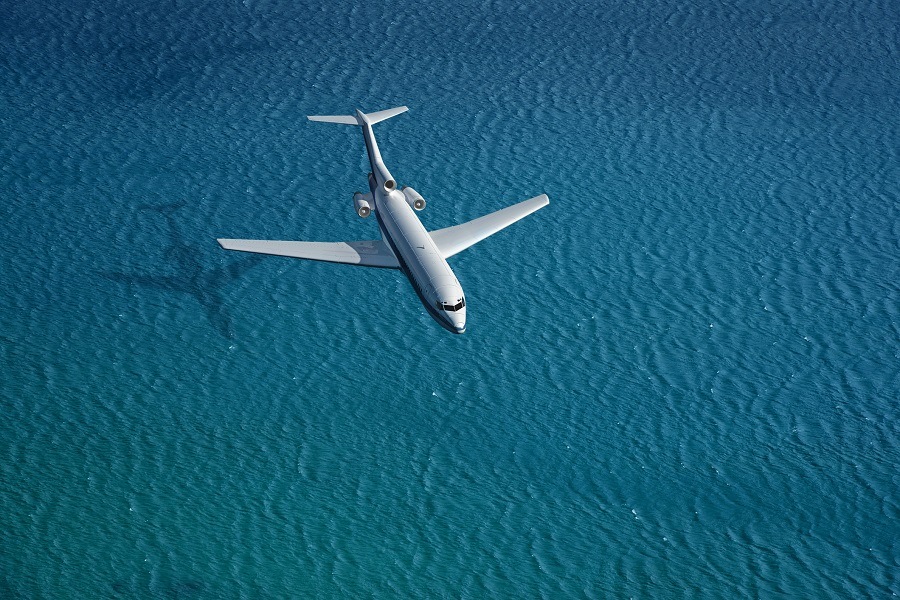 airplane flies over a sea