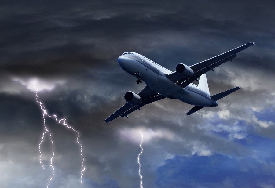 Passenger air plane approaching turbulent thunder storm lightning