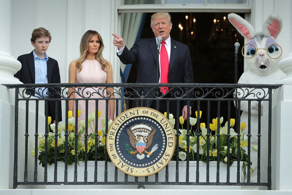 U.S. President Donald Trump delivers remarks from the Truman Balcony with first lady Melania Trump and their son Barron Trump on the South Lawn of the White House