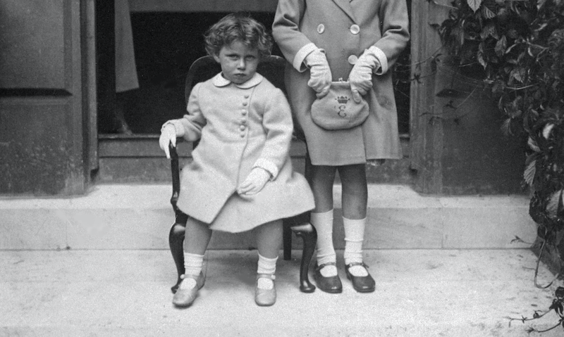 Princess Margaret sitting in a small chair. 