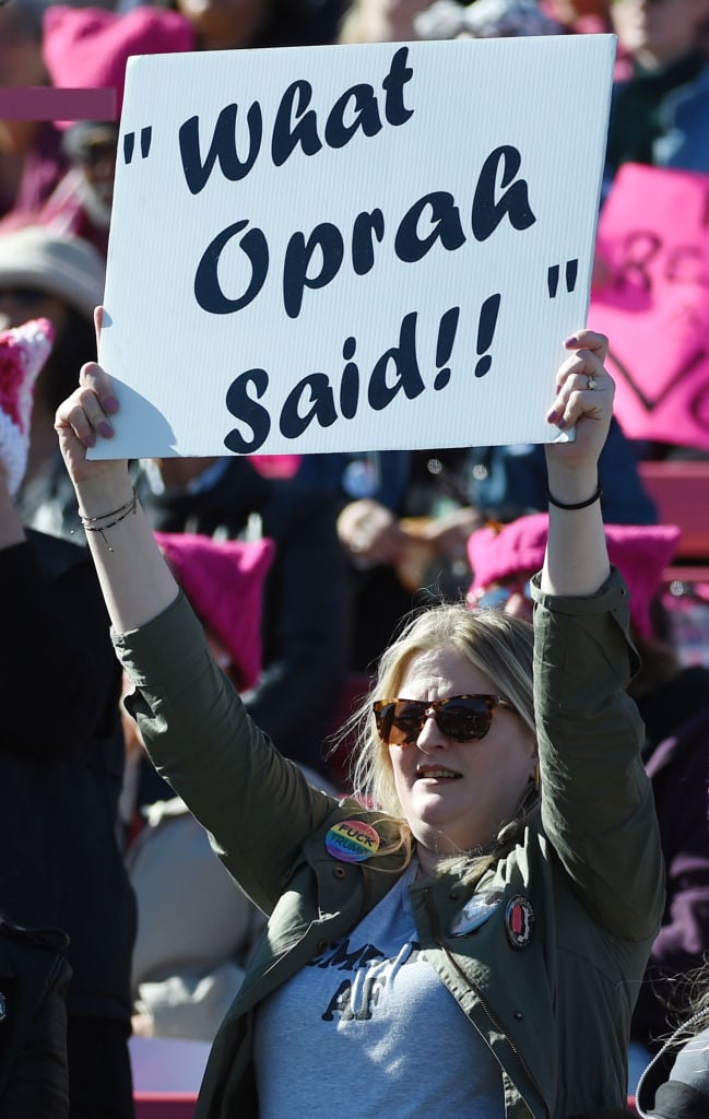Protesting woman holding sign that says "what oprah said"
