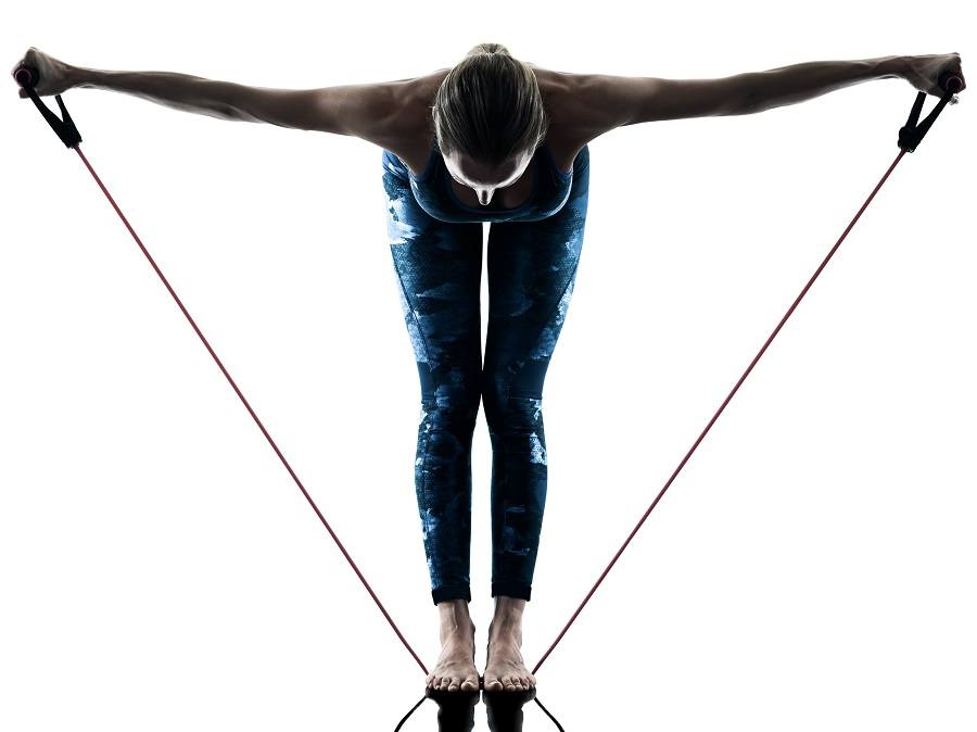 woman using resistance bands woman using resistance bands