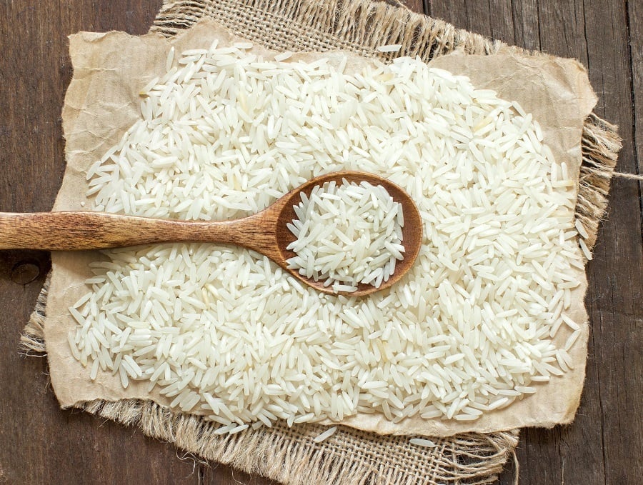 Basmati rice with a spoon on an dark wood Basmati rice with a spoon on an dark wood