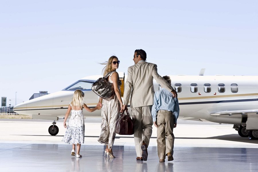 A well-dressed family ready to board a plane